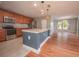 Modern kitchen with stainless steel appliances, a spacious island, and hardwood floors at 2100 Forest Cir, Orlando, FL 32803