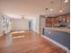 Open-concept living area with hardwood floors seamlessly connecting the kitchen and living room at 2100 Forest Cir, Orlando, FL 32803
