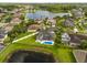 Stunning aerial view of a home featuring a private pool and beautiful lake views in a desirable neighborhood at 218 Pebblerock Ct, Orlando, FL 32828