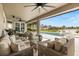 This outdoor patio features ample seating and a beautiful view of the pool and landscaped backyard at 218 Pebblerock Ct, Orlando, FL 32828