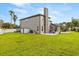 Spacious backyard featuring a well-maintained lawn, storage shed, and outdoor grilling area at 218 Pebblerock Ct, Orlando, FL 32828