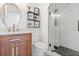 Modern bathroom featuring a wood vanity, tiled shower with glass door, and decorative accents at 218 Pebblerock Ct, Orlando, FL 32828