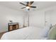 Cozy bedroom featuring hardwood floors, modern ceiling fan and a decorative console at 218 Pebblerock Ct, Orlando, FL 32828