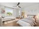 Bright bedroom featuring hardwood floors, stylish ceiling fan, and window overlooking the neighborhood at 218 Pebblerock Ct, Orlando, FL 32828