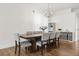 Bright dining room with wood table, gray upholstered chairs, and modern chandelier at 218 Pebblerock Ct, Orlando, FL 32828