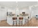 Bright and open kitchen featuring white cabinets, stainless steel appliances, and a breakfast bar with seating at 218 Pebblerock Ct, Orlando, FL 32828