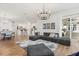 Open-concept floorplan combines the living room with a cozy sectional sofa and adjacent kitchen and dining area at 218 Pebblerock Ct, Orlando, FL 32828