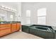 Main bathroom with a tub, natural light and dual sinks at 218 Pebblerock Ct, Orlando, FL 32828
