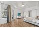 Main bedroom with tray ceilings, wood floors, walk-out patio and a modern dresser at 218 Pebblerock Ct, Orlando, FL 32828