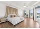 Spacious main bedroom with tray ceilings, wood floors and windows to the pool and lake at 218 Pebblerock Ct, Orlando, FL 32828