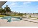 Beautiful in-ground swimming pool and spa, overlooking a serene lake at 218 Pebblerock Ct, Orlando, FL 32828