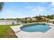 This is an in-ground swimming pool featuring a spa with a serene lake view at 218 Pebblerock Ct, Orlando, FL 32828