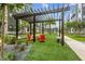 Pergola with seating area surrounded by lush landscaping in residential community at 2233 Valentine Aly, Orlando, FL 32804