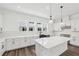 Modern kitchen features white cabinets, stainless steel appliances, an island and pendant lighting at 2233 Valentine Aly, Orlando, FL 32804