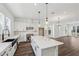 Modern kitchen with an open concept layout with stainless appliances, an island, and dark wood floors at 2233 Valentine Aly, Orlando, FL 32804
