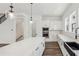 Modern kitchen boasts a center island, stainless steel appliances, white cabinetry and hardwood floors at 2233 Valentine Aly, Orlando, FL 32804