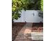Brick walkway leading to a backyard gate and white vinyl fence at 2325 E Harding Street, Orlando, FL 32806