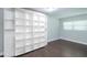 Bedroom with hardwood flooring, baseboard molding and custom built-in shelving at 2325 E Harding Street, Orlando, FL 32806