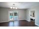 Dining room with French doors that lead to a pool area and a view into the bedroom at 2325 E Harding Street, Orlando, FL 32806