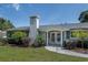 Charming home with a brick chimney, white columns and a well-manicured lawn at 2325 E Harding Street, Orlando, FL 32806