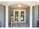 Charming front porch with rocking chair and double doors at 2325 E Harding Street, Orlando, FL 32806
