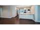 The modern kitchen is open and bright, with stainless steel appliances, white cabinetry, and wood flooring at 2325 E Harding Street, Orlando, FL 32806