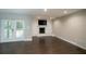 Inviting living room featuring a white brick fireplace and wood-look tile flooring at 2325 E Harding Street, Orlando, FL 32806