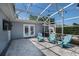 A covered patio area featuring comfortable seating and a mounted TV for outdoor entertainment at 2325 E Harding Street, Orlando, FL 32806