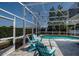 Relax poolside with string lights, Adirondack chairs and a lush privacy hedge at 2325 E Harding Street, Orlando, FL 32806