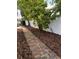 Brick walkway with landscape design of mulch and a white vinyl fence at 2325 E Harding Street, Orlando, FL 32806