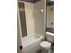 Standard bathroom featuring a shower-tub combo and a white commode at 2826 Osprey Cove Pl # 103, Kissimmee, FL 34746