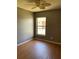 Neutral bedroom offering a ceiling fan, laminate flooring, and a window at 2826 Osprey Cove Pl # 103, Kissimmee, FL 34746
