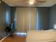 Relaxing bedroom with dark gray walls, wood floors, and large windows providing natural light at 2826 Osprey Cove Pl # 103, Kissimmee, FL 34746