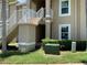 Exterior of a multi-unit building with staircases, landscaping, and clearly marked unit numbers at 2826 Osprey Cove Pl # 103, Kissimmee, FL 34746