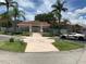 Community entrance with well-maintained landscaping and gated access at 2826 Osprey Cove Pl # 103, Kissimmee, FL 34746