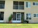 Exterior view of screened-in patios and lawn area at 2826 Osprey Cove Pl # 103, Kissimmee, FL 34746