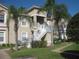 Charming condo featuring a two-story entrance and beautifully maintained landscaping with mature palms at 2826 Osprey Cove Pl # 103, Kissimmee, FL 34746