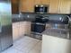 Kitchen featuring stainless steel appliances, light wood cabinets, and granite countertops at 2826 Osprey Cove Pl # 103, Kissimmee, FL 34746