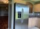 Kitchen featuring a stainless steel refrigerator with a water dispenser and neutral countertops and cabinets at 2826 Osprey Cove Pl # 103, Kissimmee, FL 34746