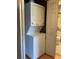 A close up view of a stacked washer and dryer in a laundry closet at 2826 Osprey Cove Pl # 103, Kissimmee, FL 34746