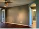 View of the living room showing wood flooring leading to a hallway with bathroom at 2826 Osprey Cove Pl # 103, Kissimmee, FL 34746