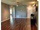 Living room featuring hardwood floors and a neutral paint scheme, with an open layout and a ceiling fan at 2826 Osprey Cove Pl # 103, Kissimmee, FL 34746