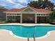 Community pool with a red-tiled roof cabana at 2826 Osprey Cove Pl # 103, Kissimmee, FL 34746