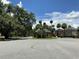 Neighborhood street view featuring mature trees and well-maintained landscaping, creating a serene living environment at 2826 Osprey Cove Pl # 103, Kissimmee, FL 34746