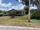 Charming single-story home featuring a cozy screened porch and well-maintained landscaping, enhancing curb appeal at 3411 Hughey St, Sanford, FL 32771