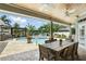 Inviting outdoor dining area overlooking a sparkling pool and lush tropical landscaping at 3618 Rothbury Dr, Belle Isle, FL 32812