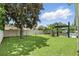 Expansive backyard with lush lawn and an outdoor grilling area next to the pool at 3618 Rothbury Dr, Belle Isle, FL 32812