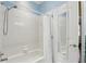 Clean and functional bathroom featuring a shower-tub combo with white tile and a mirrored door at 3618 Rothbury Dr, Belle Isle, FL 32812