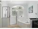 Bright bathroom featuring a glass shower, soaking tub, and natural light at 3618 Rothbury Dr, Belle Isle, FL 32812