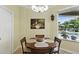 Cozy breakfast nook with pool view, art, and a decorative light fixture provides an inviting space to dine at 3618 Rothbury Dr, Belle Isle, FL 32812